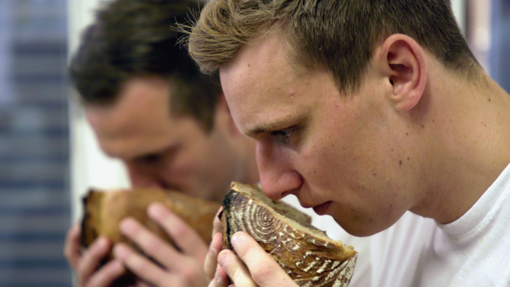 Photo from film, smelling bread loaves